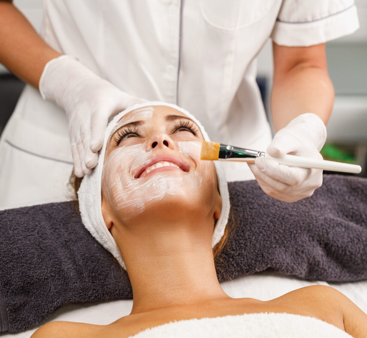 Shot of a beautiful young woman getting a facial mask treatment at the beauty salon.
